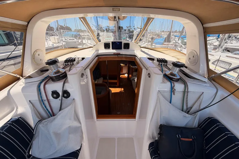 Slide: The Image of Interior view of a 2007 Saga 409 sailboat cockpit with marina background. - 53