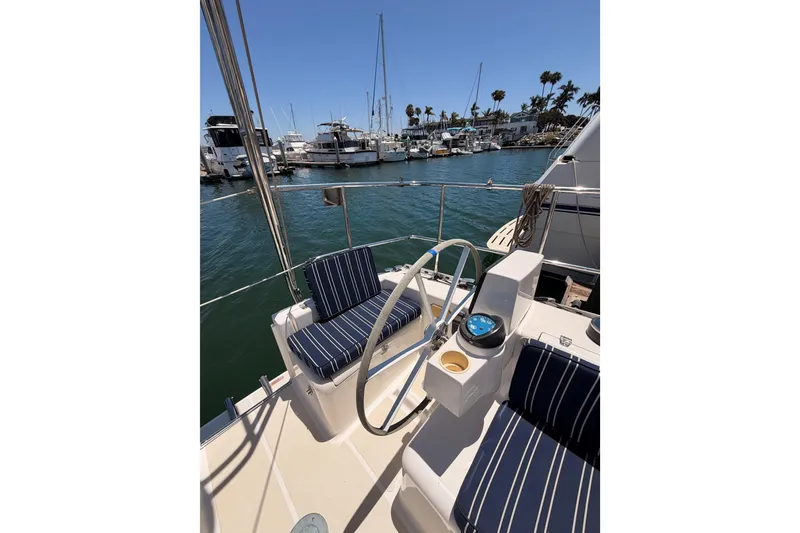 Slide: The Image of Cockpit of 2007 Saga 409 sailboat with striped seating, docked in a marina. - 35