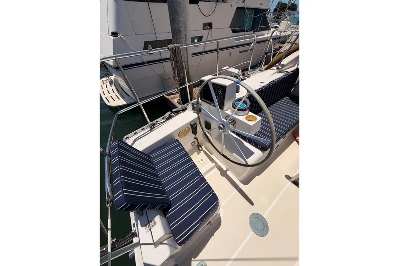 Slide: The Image of Cockpit of 2007 Saga 409 sailboat with striped seating and steering wheel. - 40