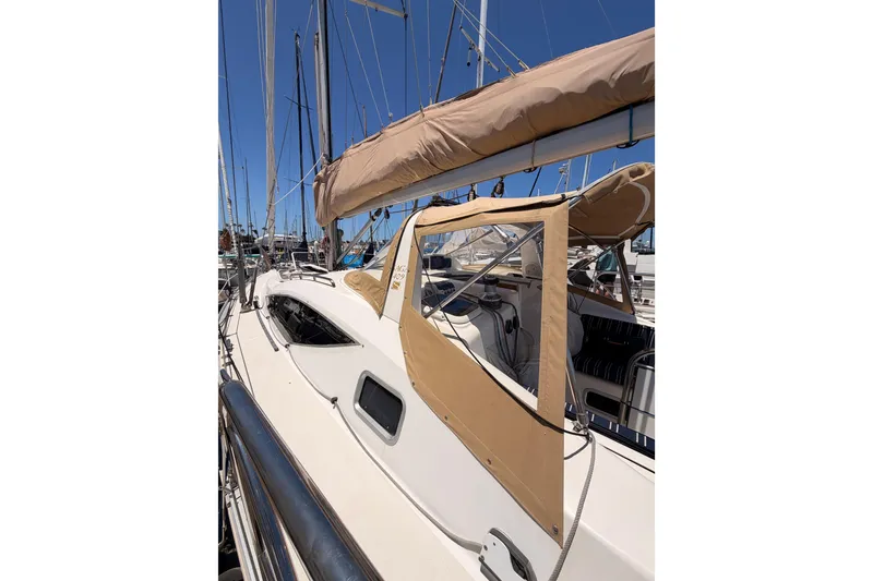 Slide: The Image of Sailing yacht Saga 409, 2007 model, docked with beige canopy and clear windows. - 16