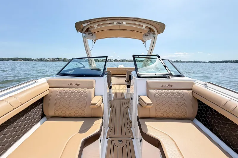 Slide: The Image of 2021 Sea Ray SDX 270 Outboard boat interior with tan seating on a sunny day. - 14
