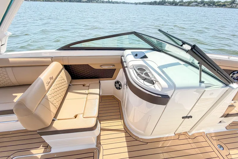 Slide: The Image of 2021 Sea Ray SDX 270 Outboard interior with tan seating and sleek design on the water. - 16