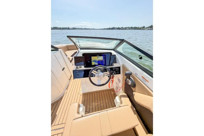 Slide: The Image of 2021 Sea Ray SDX 270 Outboard boat interior with steering wheel and navigation display. - 7