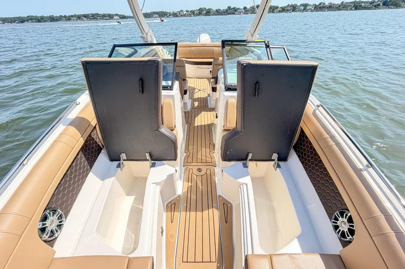 Slide: The Image of 2021 Sea Ray SDX 270 Outboard boat interior with tan seating and open water view. - 21