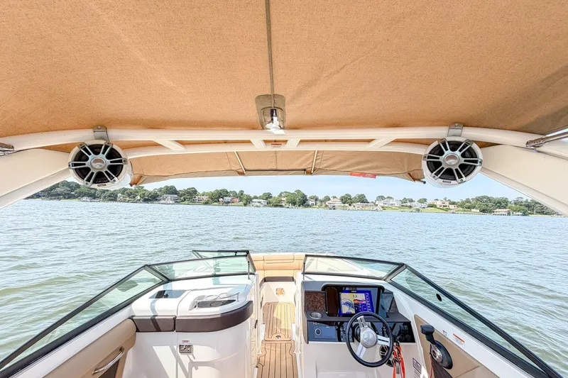 Slide: The Image of 2021 Sea Ray SDX 270 Outboard boat interior with canopy and water view. - 22