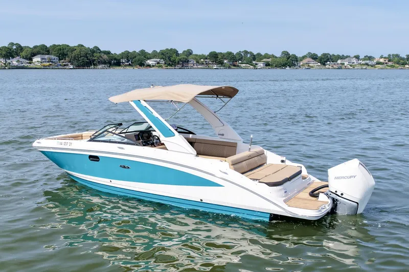 Slide: The Image of 2021 Sea Ray SDX 270 Outboard boat on calm water, featuring a sleek design and Mercury engine. - 5