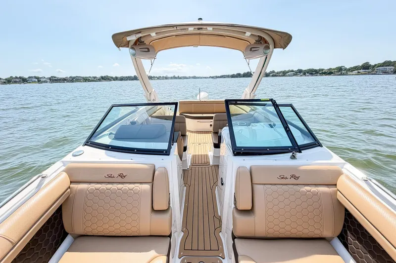 Slide: The Image of 2021 Sea Ray SDX 270 Outboard boat interior with tan seating on a sunny day. - 13
