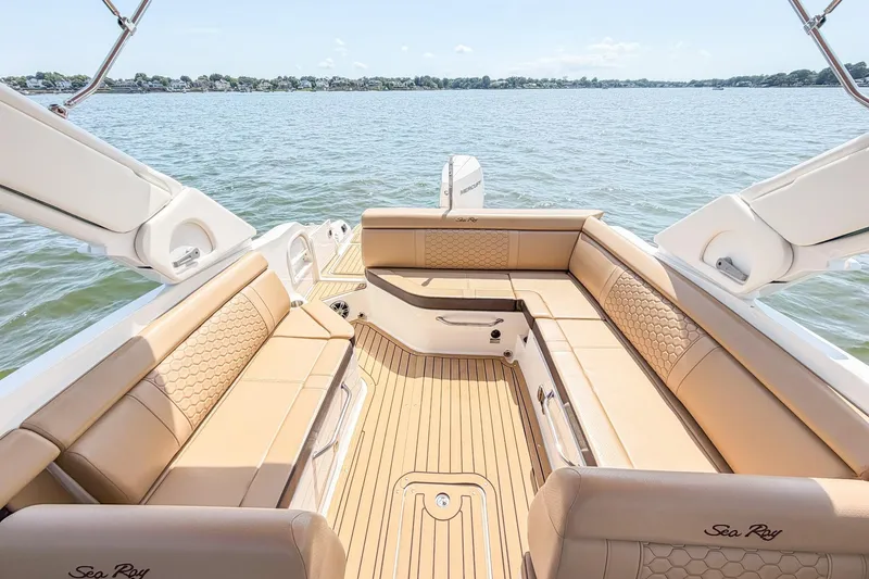 Slide: The Image of 2021 Sea Ray SDX 270 Outboard boat interior with tan seating on a sunny day. - 19