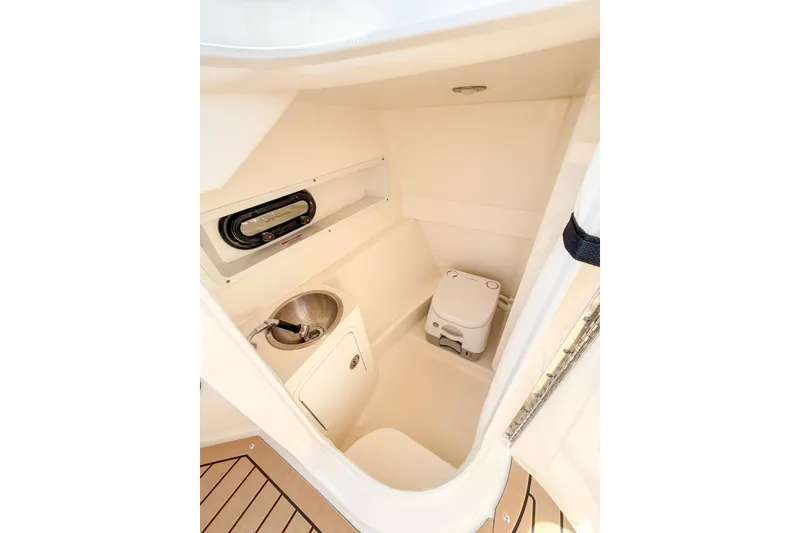 Slide: The Image of 2021 Sea Ray SDX 270 Outboard boat interior with compact bathroom amenities. - 17