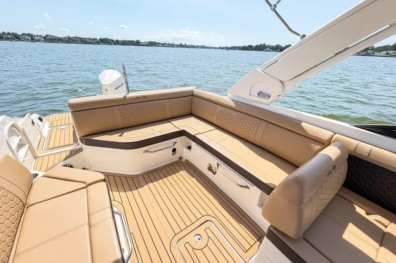 Slide: The Image of 2021 Sea Ray SDX 270 Outboard boat with luxurious tan seating and scenic water view. - 18