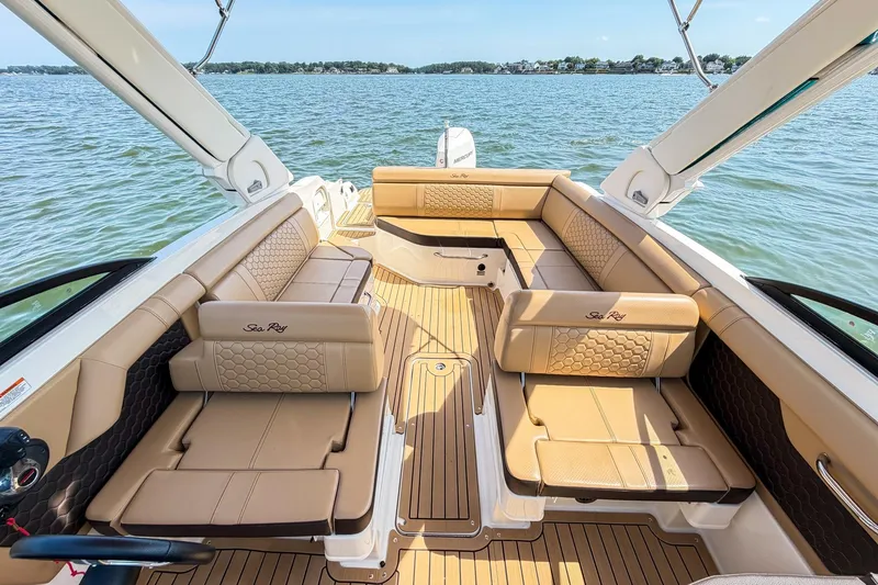 Slide: The Image of 2021 Sea Ray SDX 270 Outboard boat interior with luxurious tan seating on open water. - 15