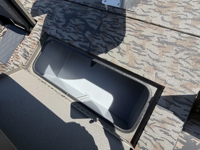 Slide: The Image of An open storage compartment on a boat with camouflage pattern. - 6
