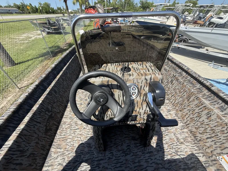 Slide: The Image of The image shows the cockpit of an Xpress XP20CC boat with a camouflage design. - 5