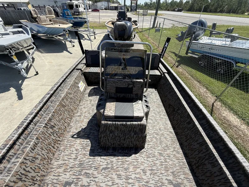 Slide: The Image of The image shows a 2027 Xpress XP20CC boat with a camouflage design, parked on a lot. - 8