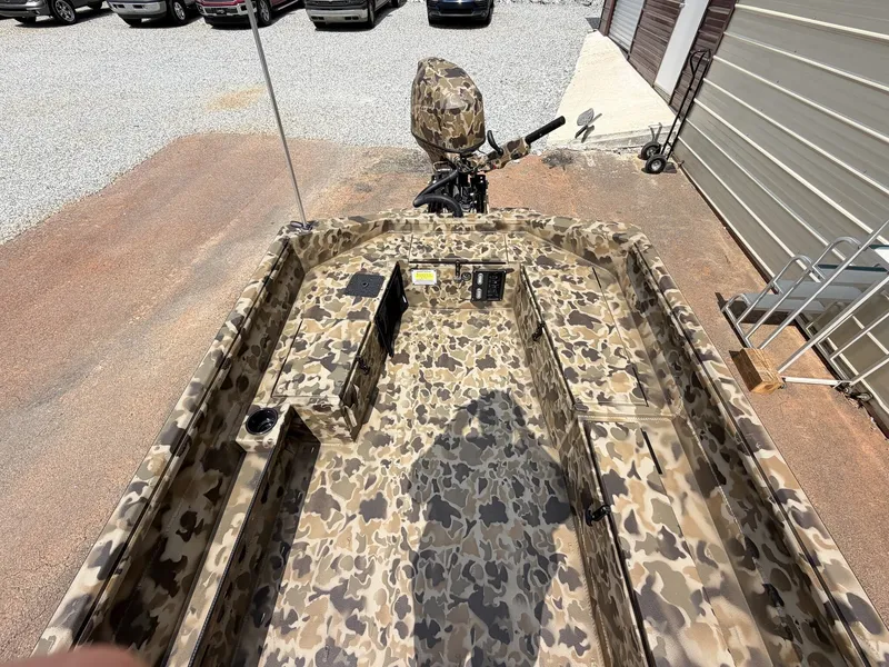 Slide: The Image of An Excel Viper F4 1751 boat with camouflage pattern, parked on an aluminum trailer. - 6