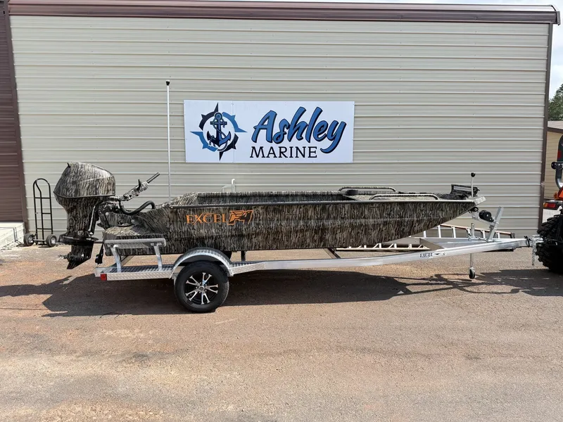 The Image of An Excel Viper F4 1751 aluminum boat on a trailer in front of a building. - 1