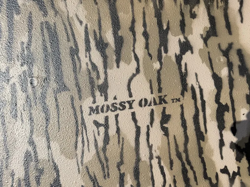 Slide: The Image of Close-up of a Mossy Oak camouflage pattern on a surface. - 7