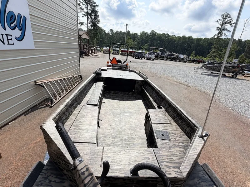 Slide: The Image of An Excel Viper F4 1751 aluminum boat on a trailer, surrounded by trees and buildings. - 9
