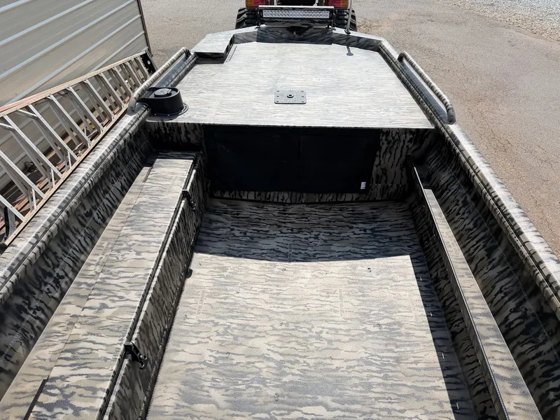 Slide: The Image of The image shows a sturdy aluminum boat with a camouflage pattern and a spacious interior. - 6