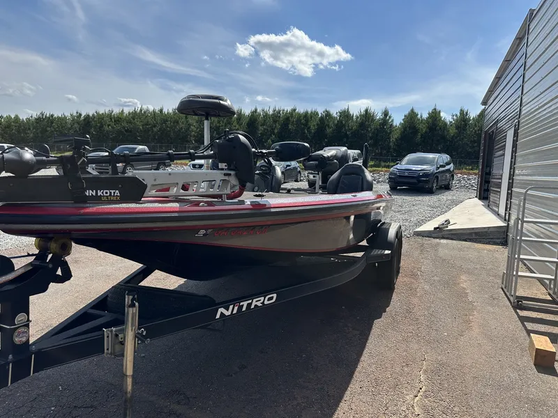 Slide: The Image of A 2017 Nitro Z Series Z19-200HP OPTI boat on a trailer beside a building. - 3