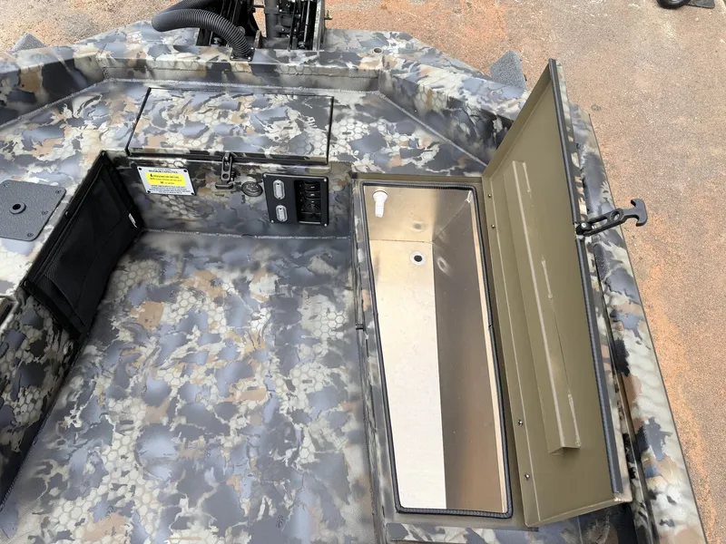 Slide: The Image of The image shows the interior of an Excel Boats Viper F4 1751 with an open storage compartment. - 10