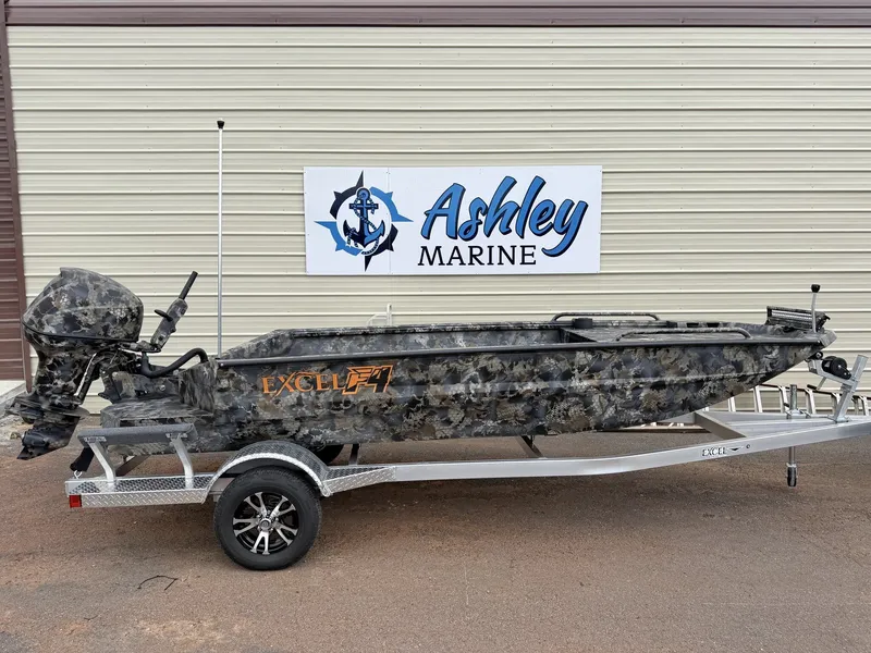 The Image of An Excel Viper F4 1751 aluminum boat on a trailer in front of a building. - 1