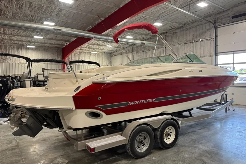 Slide: The Image of 2005 Monterey 268SS Super Sport boat in a garage, featuring a red and white design. - 3