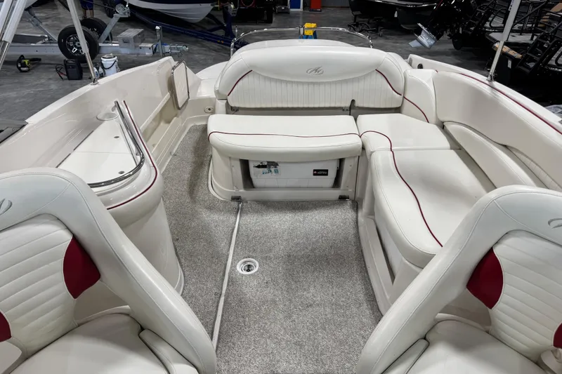 Slide: The Image of Interior of a 2005 Monterey 268SS Super Sport boat with white and red seating. - 9