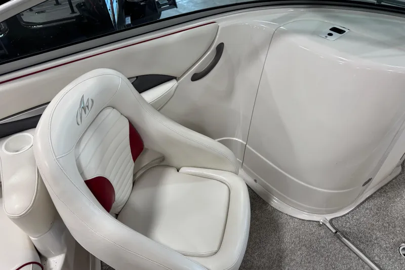 Slide: The Image of Interior of a 2005 Monterey 268SS Super Sport boat, featuring white and red seating. - 7
