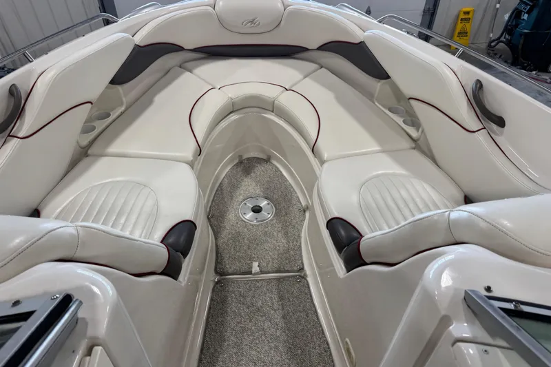 Slide: The Image of Interior of a 2005 Monterey 268SS Super Sport boat with white cushioned seating. - 8