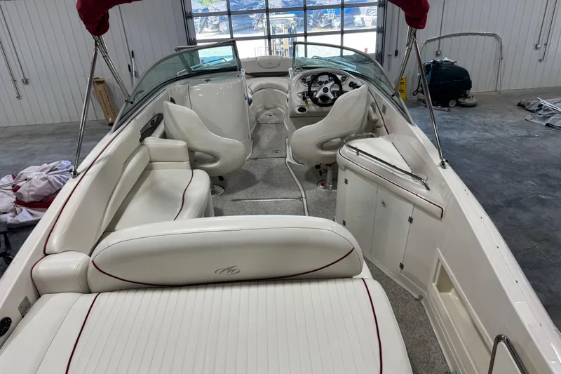 Slide: The Image of 2005 Monterey 268SS Super Sport boat interior with white seating and red accents. - 10
