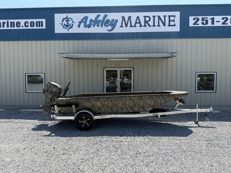 The Image of Thor Fish Hammer with Livewell and Tohatsu 60, 2027, in front of a marine store. - 1