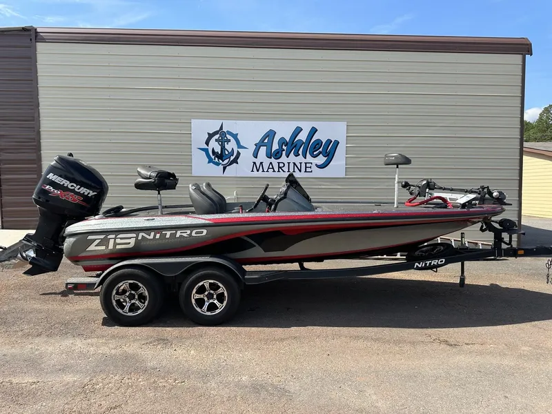 The Image of A 2017 Nitro Z Series Z19-200HP OPTI boat on a trailer in front of a building. - 1