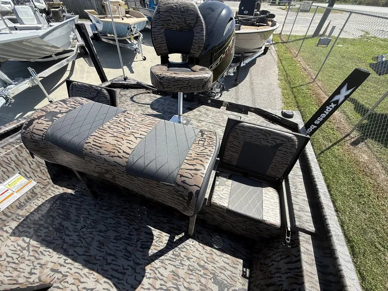 Slide: The Image of The image shows the interior of an Xpress XP20CC boat with camouflage-patterned upholstery. - 7