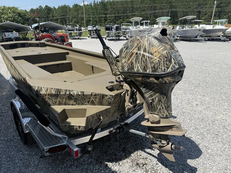 Slide: The Image of A 2027 Thor Fish Hammer boat with a Tohatsu 60 engine, on a trailer. - 4