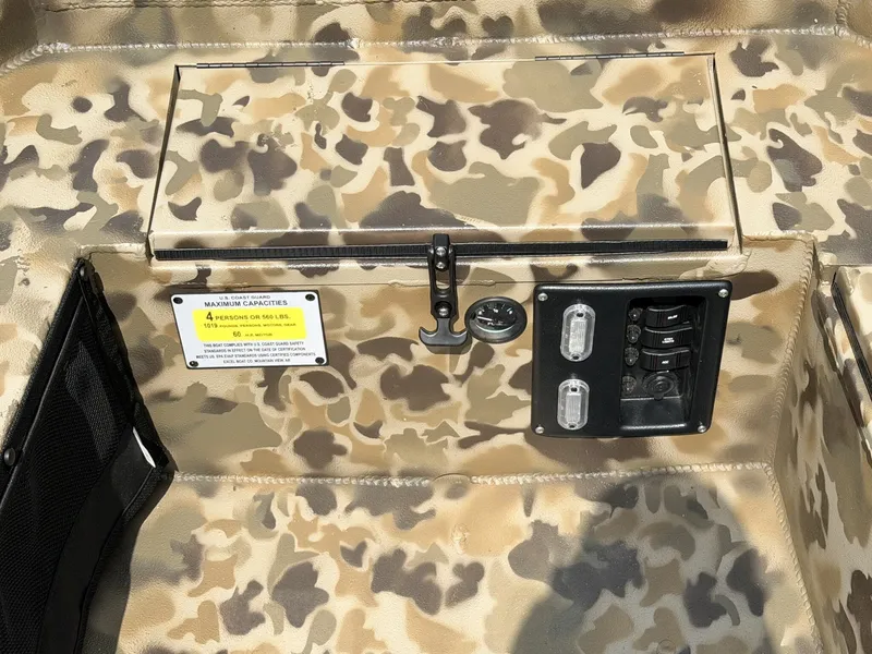 Slide: The Image of Close-up of a boat deck with camouflage pattern, switches, and a warning label. - 4