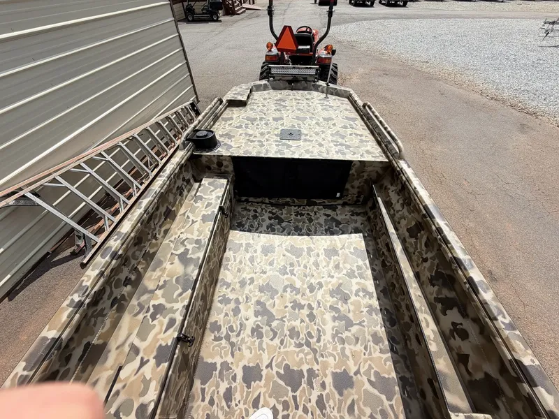 Slide: The Image of The image shows an Excel Viper F4 1751 boat with camouflage pattern on a trailer. - 5