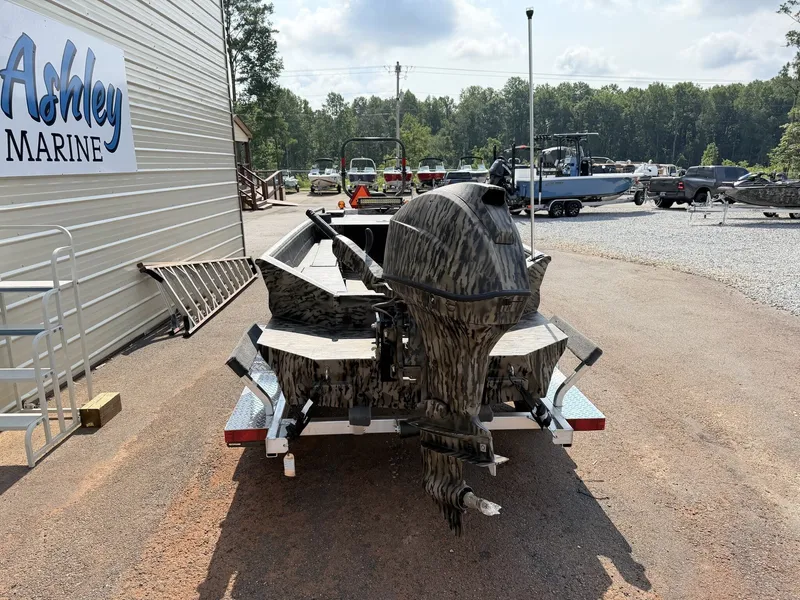 Slide: The Image of An Excel Viper F4 1751 boat on an aluminum trailer, parked on a gravel lot. - 2