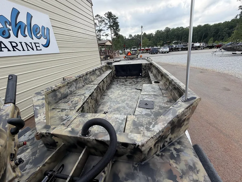 Slide: The Image of An Excel Viper F4 1751 aluminum boat with camouflage design sits on a trailer beside a building. - 9