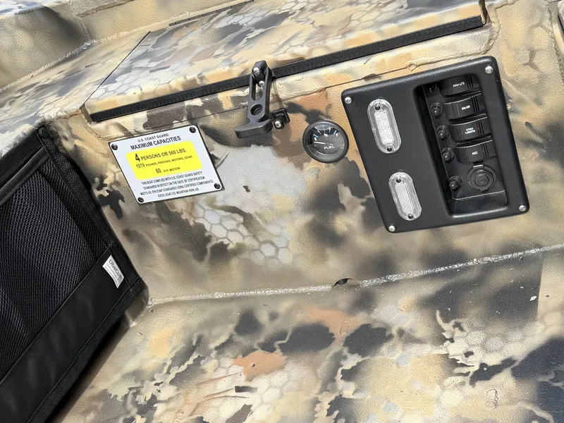 Slide: The Image of Close-up of a boat interior with camouflage pattern and switches. - 4