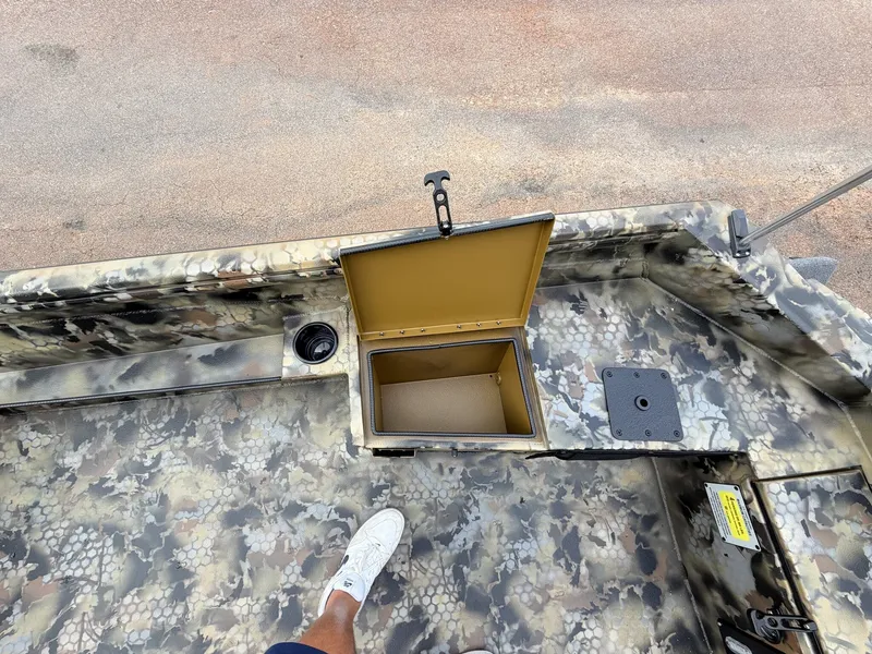 Slide: The Image of A boat with a camouflage surface and an open storage compartment. - 8