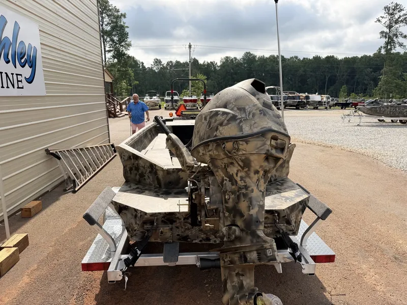Slide: The Image of Excel Boats Viper F4 1751 on an aluminum trailer, parked outdoors. - 2