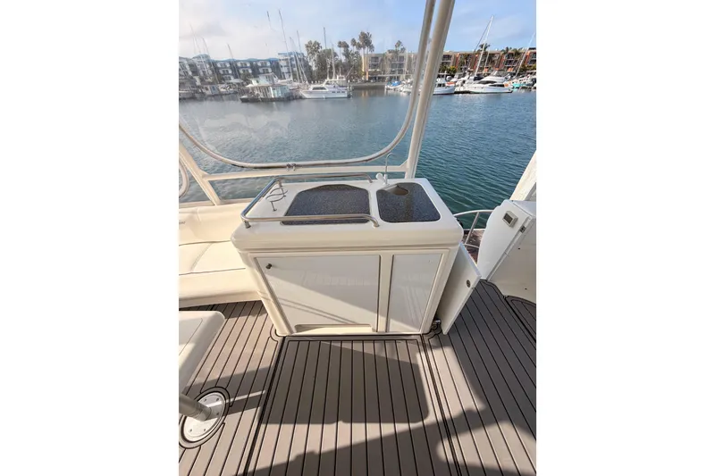Slide: The Image of 2005 Cruisers Yachts 405 Express Motoryacht deck with sink, overlooking marina. - 28