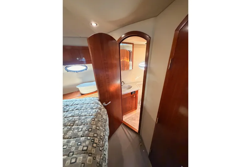 Slide: The Image of Interior of 2005 Cruisers Yachts 405 Express Motoryacht with bedroom and bathroom view. - 58
