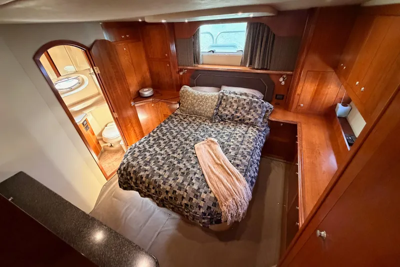 Slide: The Image of Luxurious bedroom in 2005 Cruisers Yachts 405 Express Motoryacht with elegant wood cabinetry. - 76
