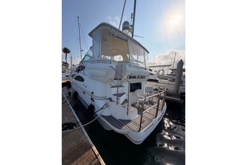 Slide: The Image of 2005 Cruisers Yachts 405 Express Motoryacht docked at marina under sunny sky. - 7