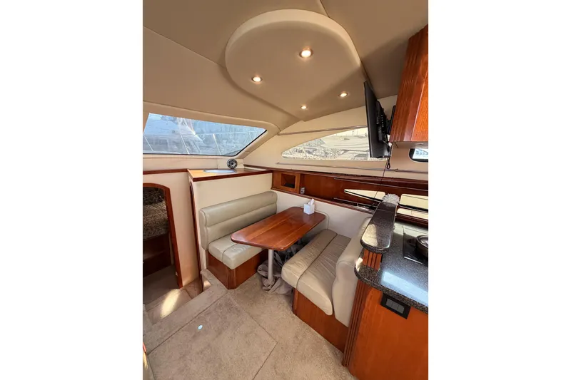 Slide: The Image of Luxurious interior of 2005 Cruisers Yachts 405 Express Motoryacht with elegant seating and dining area. - 49