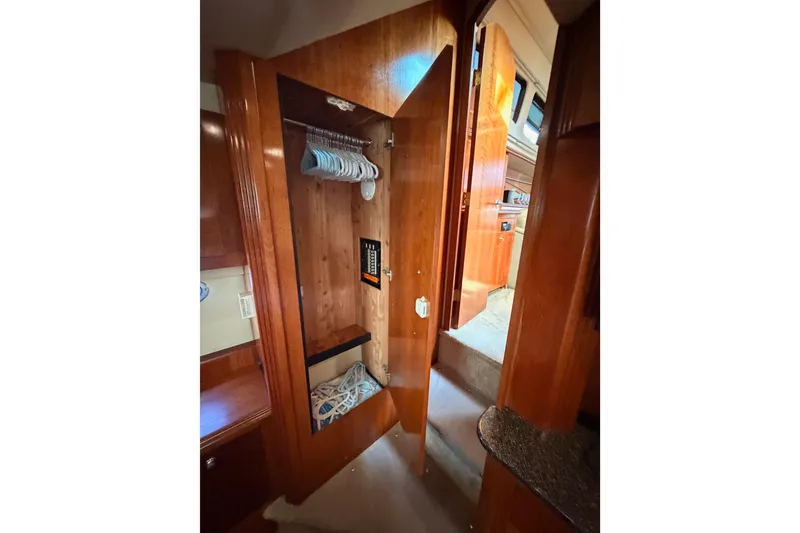 Slide: The Image of 2005 Cruisers Yachts 405 Express Motoryacht interior closet with hangers and storage space. - 85