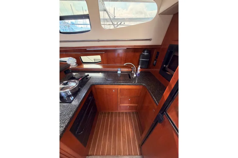 Slide: The Image of Luxurious 2005 Cruisers Yachts 405 Express Motoryacht kitchen with wood cabinetry and modern appliances. - 46