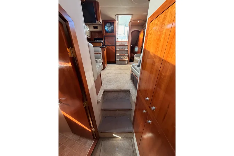 Slide: The Image of Interior of 2005 Cruisers Yachts 405 Express Motoryacht with wood cabinetry and carpeted steps. - 66